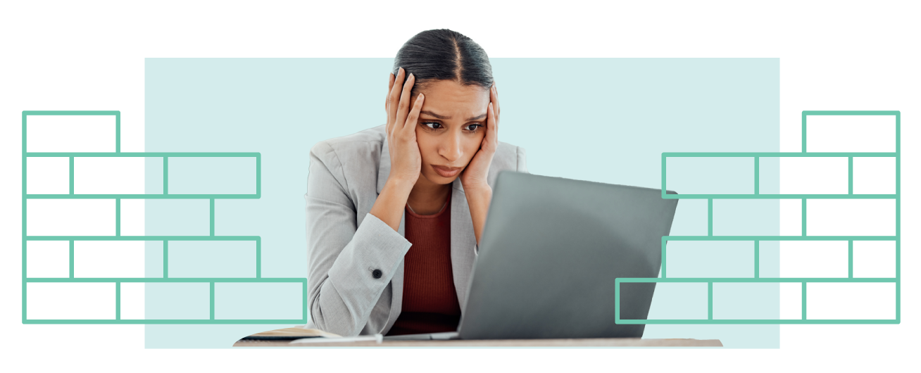Woman sitting in front of a laptop with a sad expression. A brick wall illustration is over the woman.