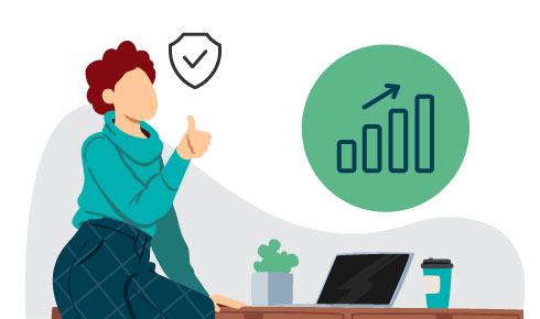 Colleague sitting at a desk with a thumbs up in front of a computer.