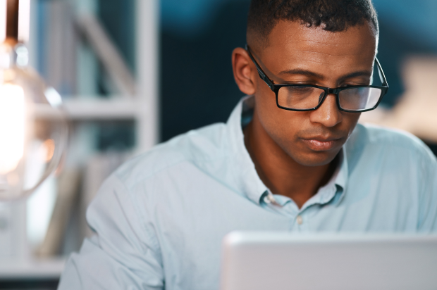 Close up of a male working on a laptop