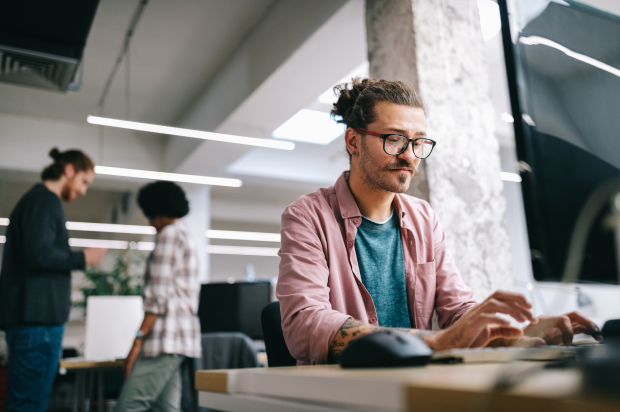 Male working at a computer in an office setting