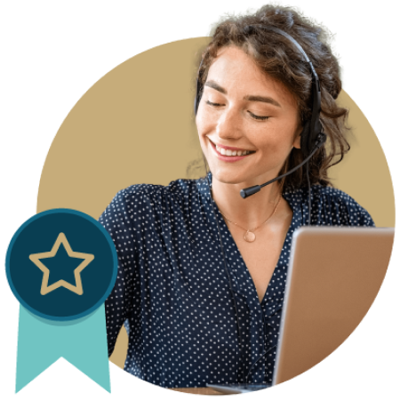 Smiling woman wearing a headset in front of a laptop with a gold-star ribbon